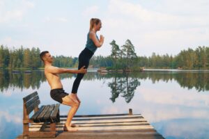 An acroyoga counterbalance where two people lean away from each other