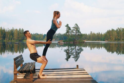 An acroyoga counterbalance where two people lean away from each other