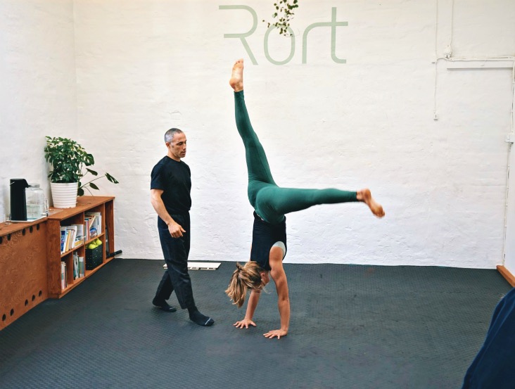 The art of handbalancing and handstand coach Yuval showing how to bail out of the handstand when she's about to fall out of a handstand