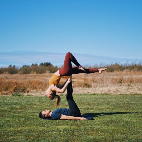 Backbird pose from acroyoga with a stag leg, which is one of the beginner friendly acroyoga poses