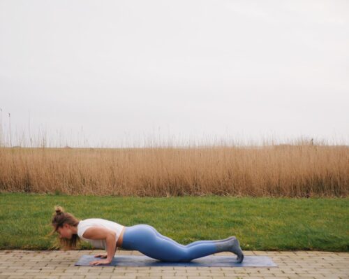 Camilla showing a chaturanga variation on knees from the sun salutations in yoga