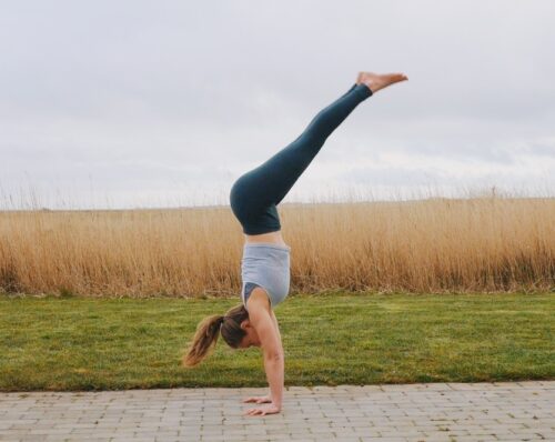 Camilla showing a pike jump entry into handstand step-by-step