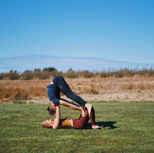 Exit from shoulderstand on knees pose from acro yoga, which is one of the intermediate friendly acro yoga postures.