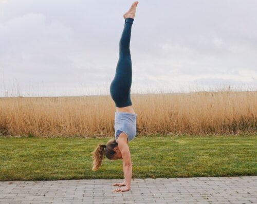 Camilla doing a straight line freestanding handstand