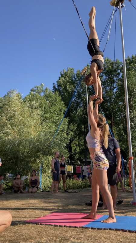 Camilla lifting another woman in a hand to hand partner acroyoga handstand wearing pitaya yoga shorts