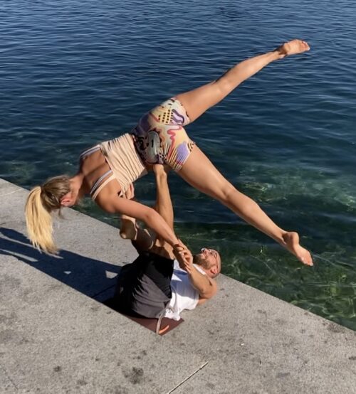 Camilla wearing pitaya yoga shorts whilst doing an acroyoga flow by lake constance in Germany