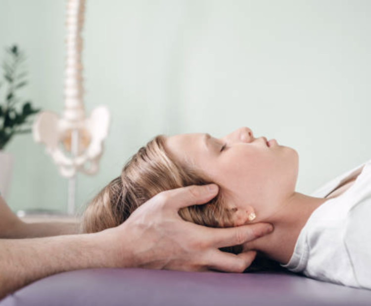 Viser hvordan osteopatisk behandling foregår med en osteopat, der har hænderne på et hoved af en klient i gang med en kraniosakral teknik i den osteopatiske behandling. Dette foregår på en osteopati klinik i København.
